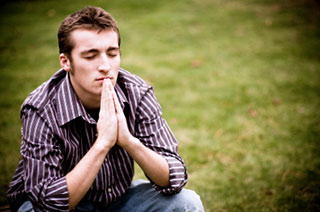 Photo of young man praying